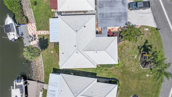 an aerial view of a city with lots of residential buildings ocean and mountain view in back