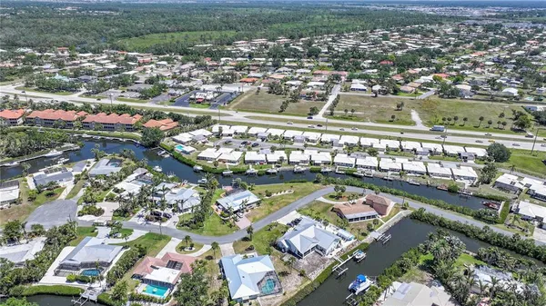 an aerial view of lake and residential houses with outdoor space