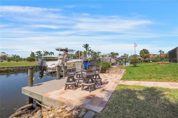 a view of a patio with a dining table and chairs with wooden fence