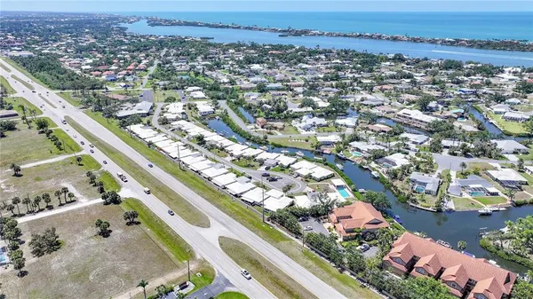 an aerial view of a city with ocean view in back
