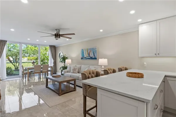 a living room with a sink a table and a potted plant