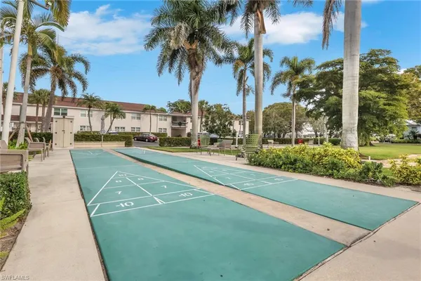 a view of a yard and cars park