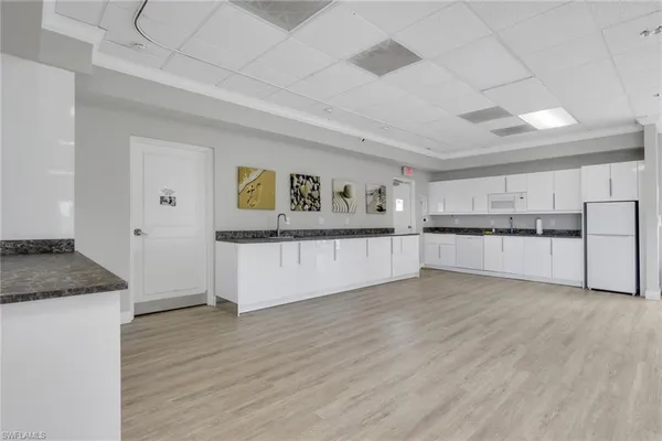 a view of a kitchen with wooden floor and a window