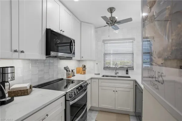 a kitchen with a sink stove and microwave