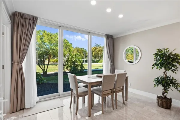 a dining room with furniture and a window