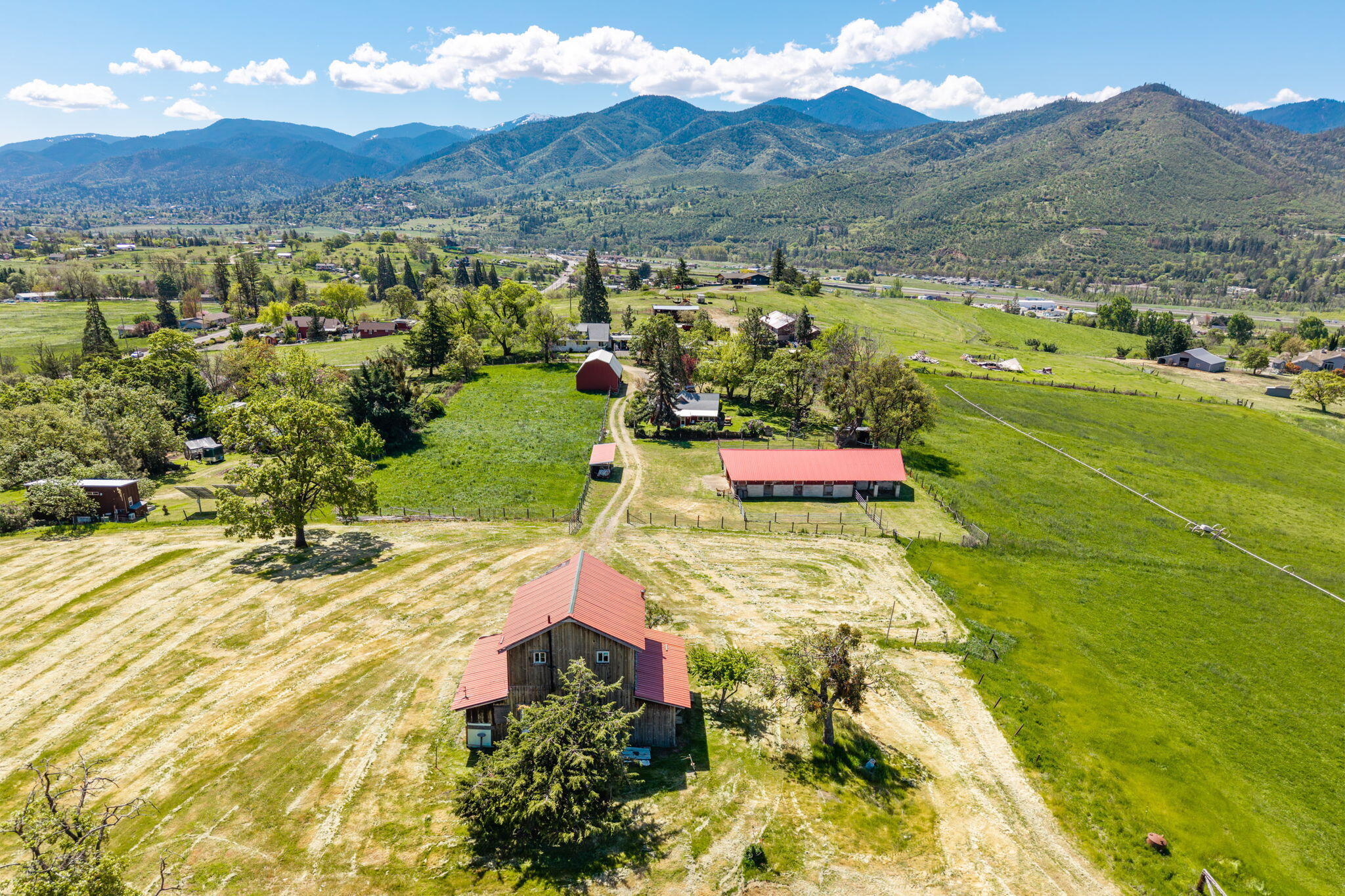 1249 North Valley View Road Ashland, OR 97520 - Photo 1 of 30 Showing barn, Horse barn, house beyond and irrigated fields.
