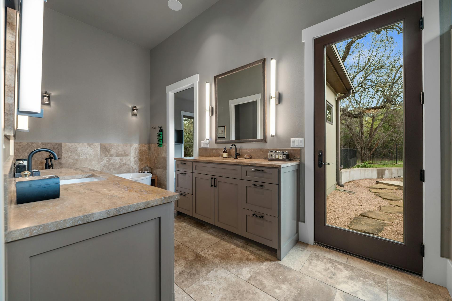 1330 Ranchers Club Lane Driftwood, TX 78619 - Photo 20 of 40 Full bath with two vanities and a tub to relax in