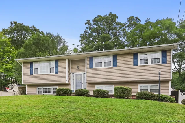 a front view of a house with a garden and plants