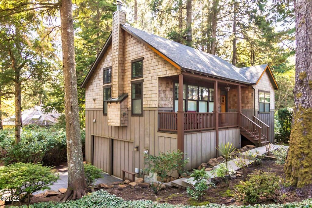 107 Ridge Crest Road Gleneden Beach, OR 97388 - Photo 2 of 3 a view of a house with a yard and plants
