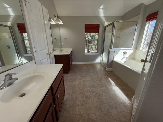 a bathroom with bathtub and shower