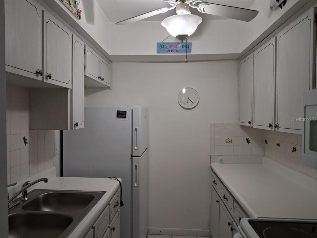 4744 Azalea Drive, Unit 204 New Port Richey, FL 34652 - Photo 8 of 20 a bathroom with a sink and cabinets