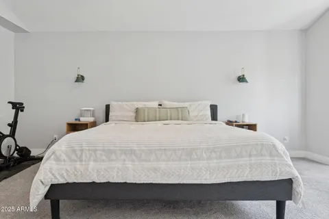 a bedroom with a bed and a table