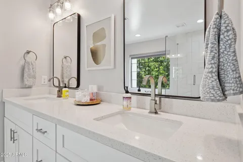 a bathroom with a double vanity sink and a mirror