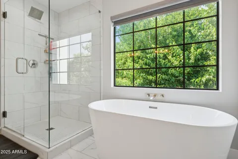 a bathroom with a bathtub and shower