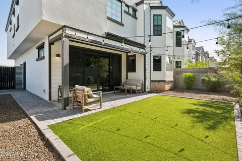 a view of a patio with table and chairs with wooden floor and fence