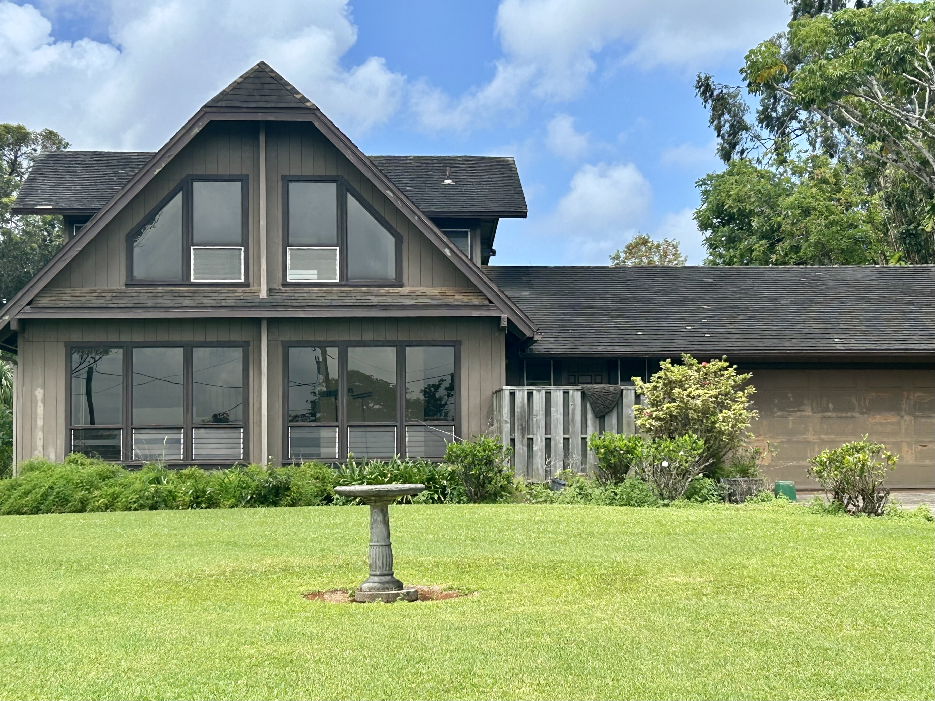5201 Puuwai Road Kalaheo, HI 96741 - Photo 1 of 1 a front view of a house with a garden and plants