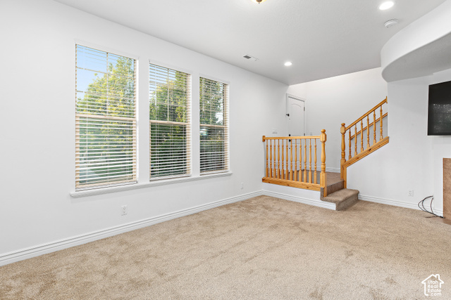 2092 Cres Drive South Mapleton, UT 84664 - Photo 4 of 26 Triple windows with white blinds, neutral carpet flooring, recessed lighting, and a wooden staircase with baluster railing