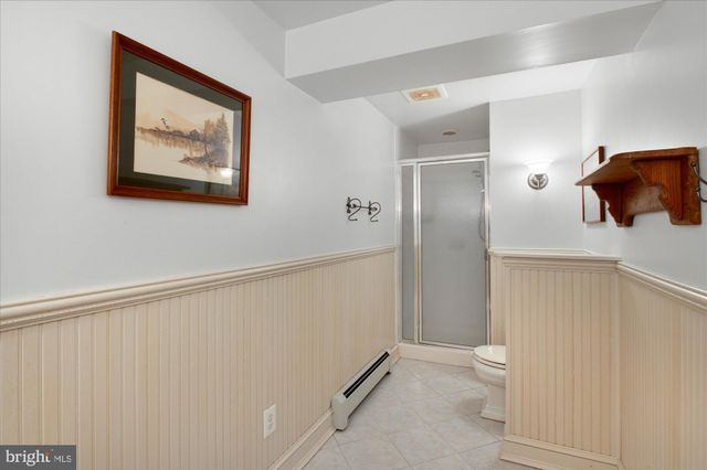 a bathroom with a shower and a toilet