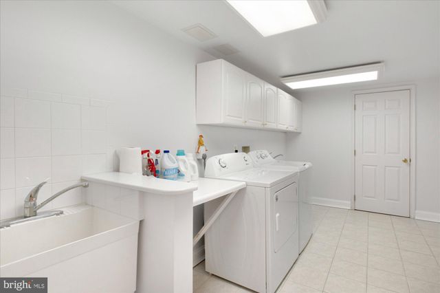 a utility room with sink dryer and washer