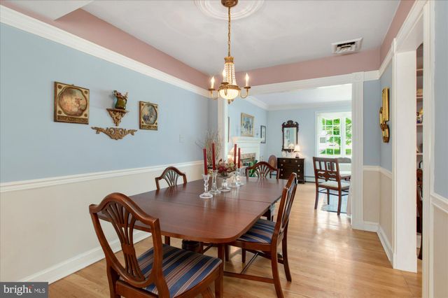 a view of a a dining room with furniture window and wooden floor