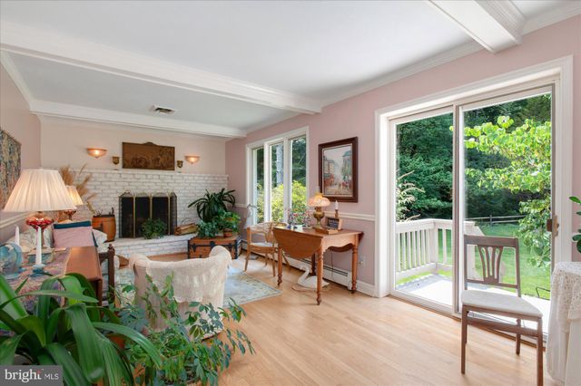 a living room with furniture fireplace and a large window