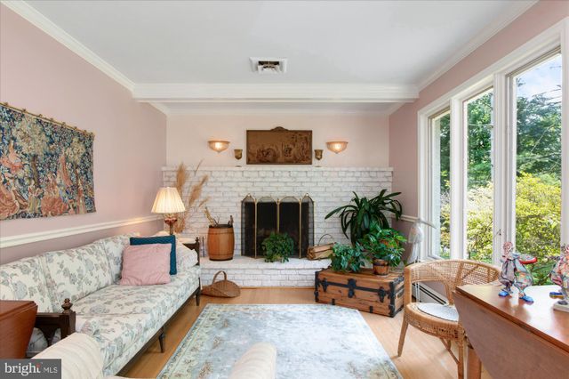 a living room with furniture large window and a fireplace