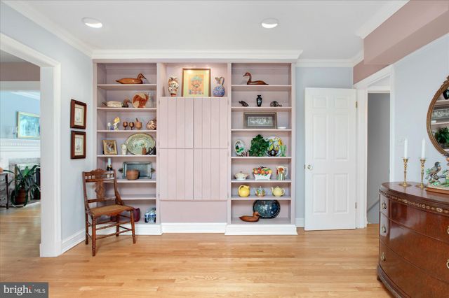 a living room with furniture and a book shelf
