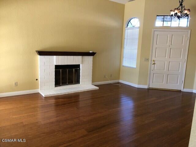890 Congressional Road Simi Valley, CA 93065 - Photo 5 of 10 an empty room with wooden floor and fireplace