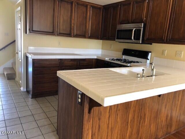 890 Congressional Road Simi Valley, CA 93065 - Photo 6 of 10 a kitchen with a sink a microwave and cabinets