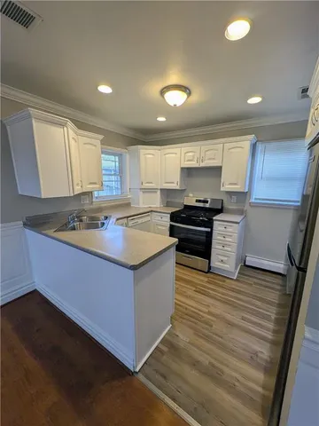 a kitchen with granite countertop a sink and cabinets