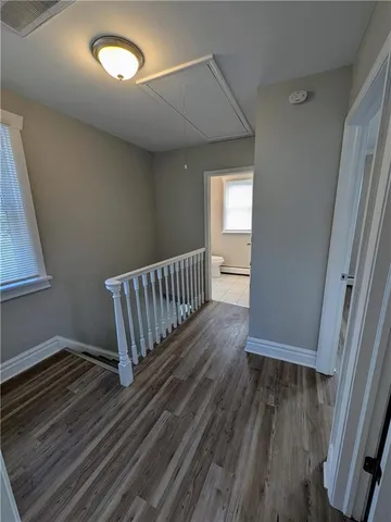 a view of a room with wooden floor and a window