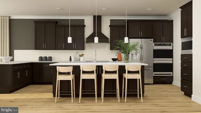 a kitchen with stainless steel appliances kitchen island granite countertop a refrigerator and wooden cabinets