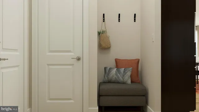 a living room with a couch and a potted plant