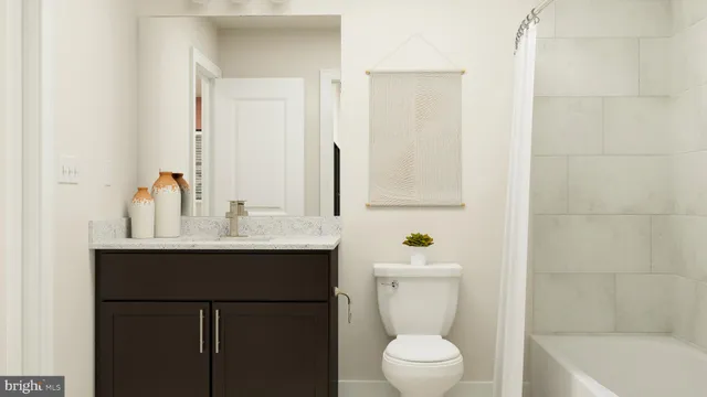 a bathroom with a sink mirror toilet and bathtub