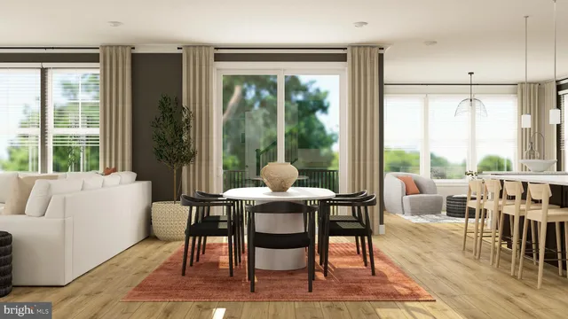 a dining room with furniture wooden floor and a rug
