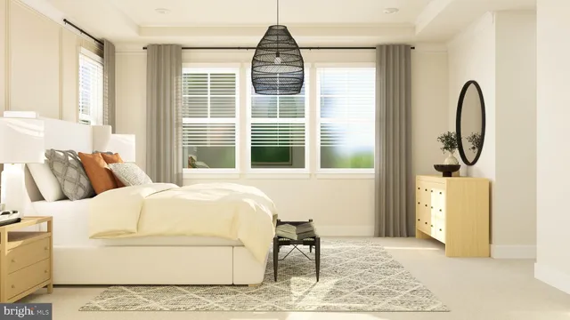 a bedroom with a bed a table and painting on the wall