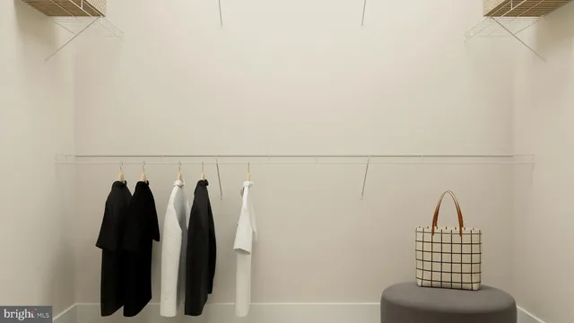 a view of walk in closet with clothes
