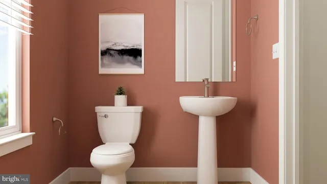a bathroom with a toilet a sink and a mirror