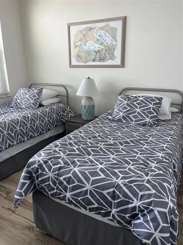 a bedroom with a bed and a painting on the wall