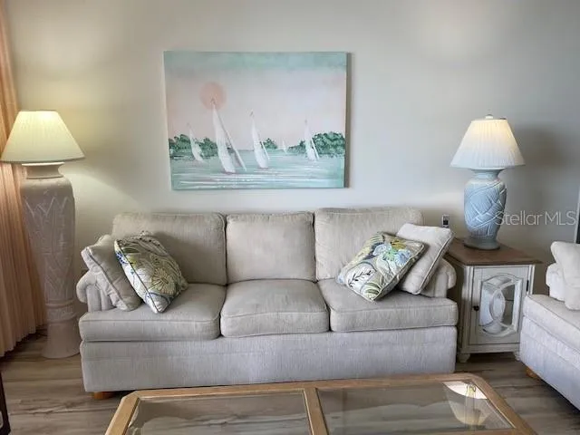 a living room with furniture and a lamp