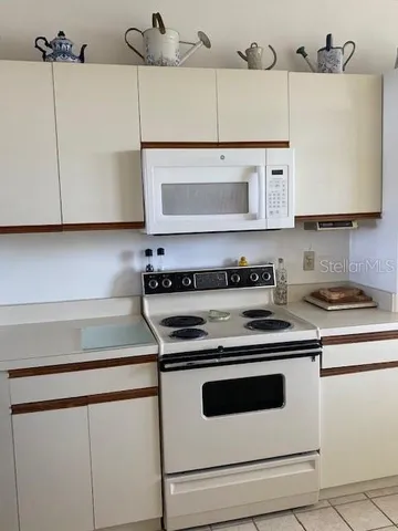 a kitchen with cabinets appliances and a sink