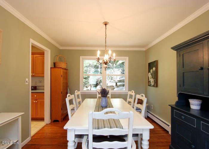211 Sheep Hill Road Riverside, CT 06878 - Photo 3 of 9 a dining room with furniture a chandelier and wooden floor
