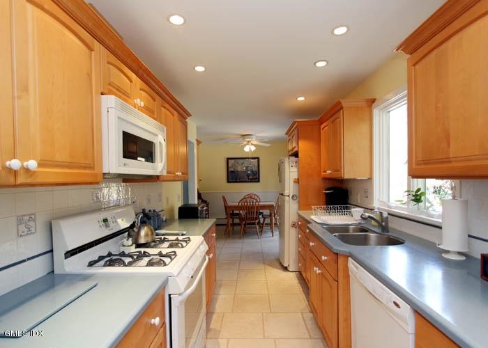 211 Sheep Hill Road Riverside, CT 06878 - Photo 4 of 9 a kitchen with stainless steel appliances a stove a sink a microwave a refrigerator and cabinets