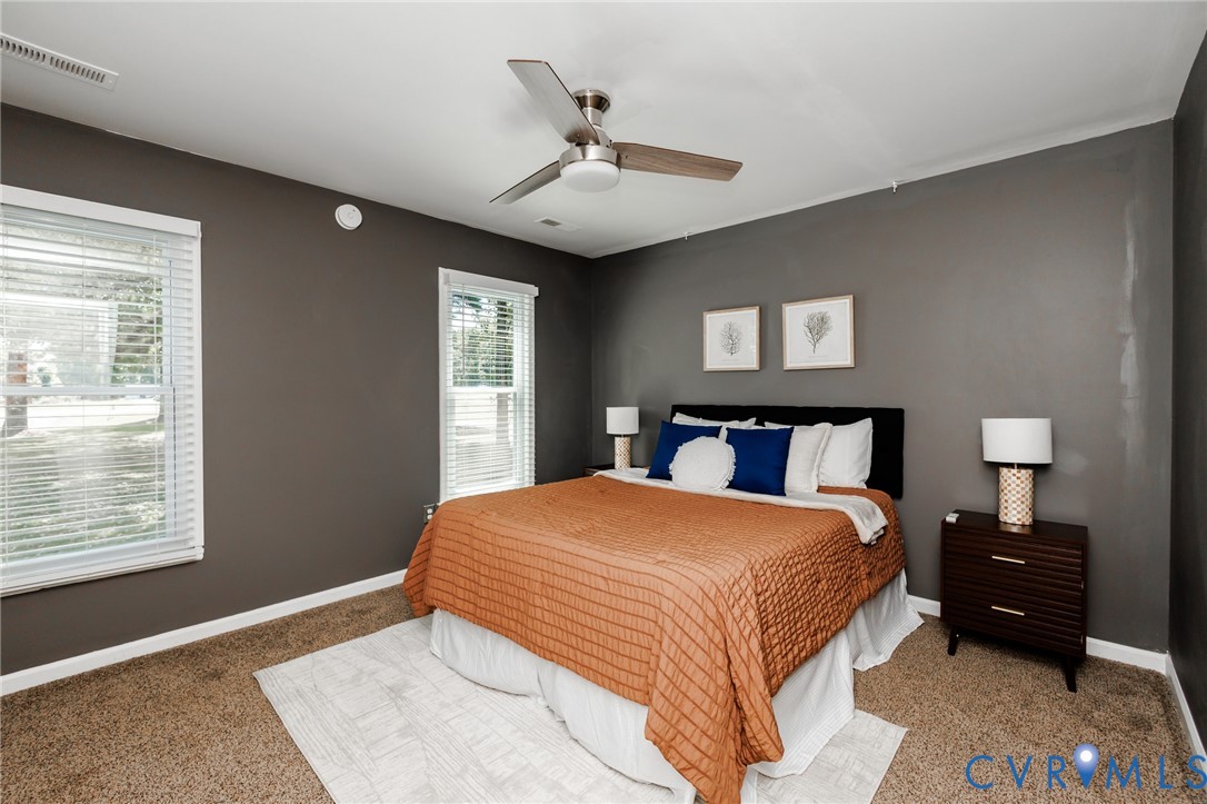 20520 Cox Road Sutherland, VA 23885 - Photo 10 of 31 Carpeted flooring, two windows with white blinds,