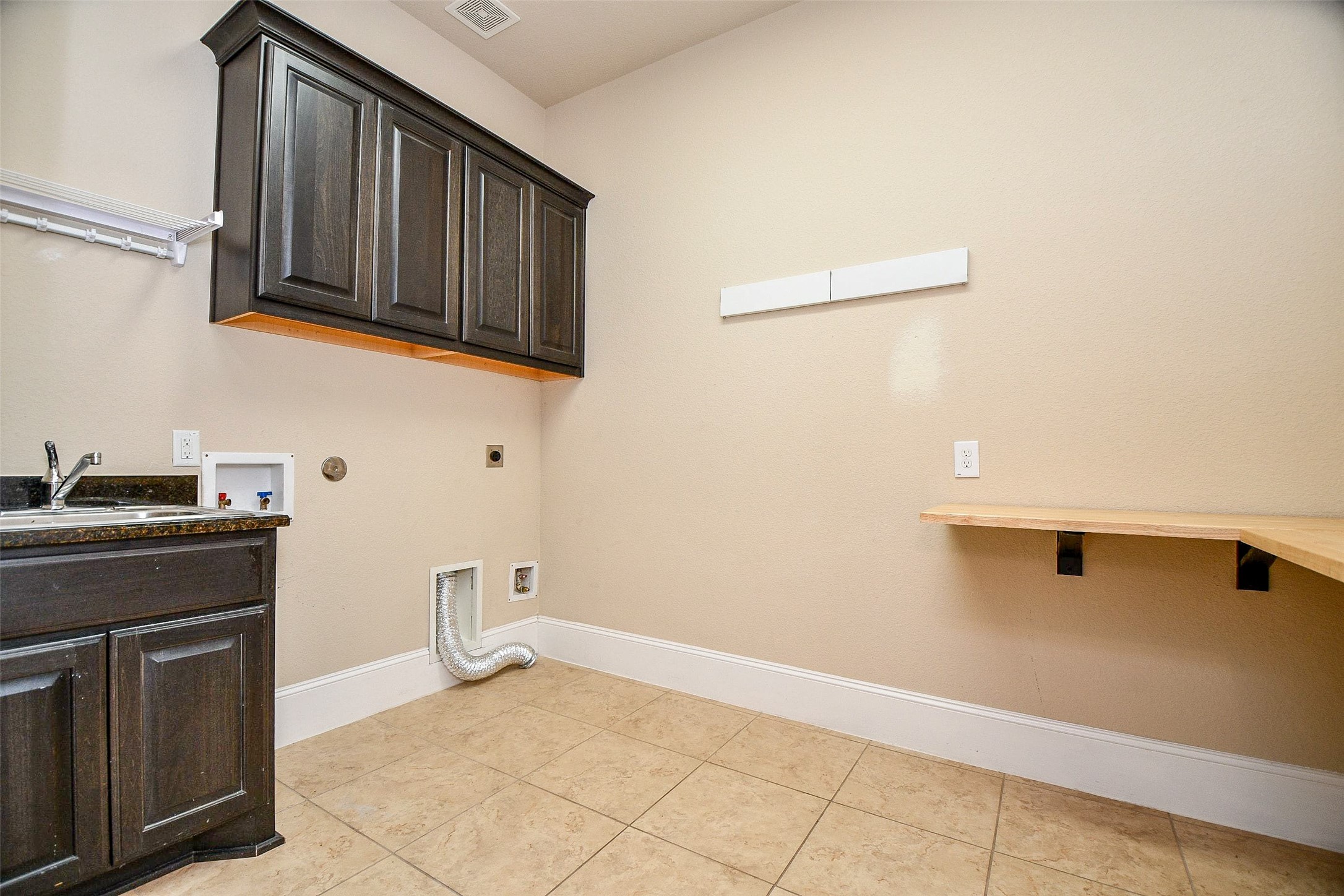 24914 Bay Mist Ridge Lane Katy, TX 77494 - Photo 17 of 50 The utility room with cabinets and a sink and extra room for storage