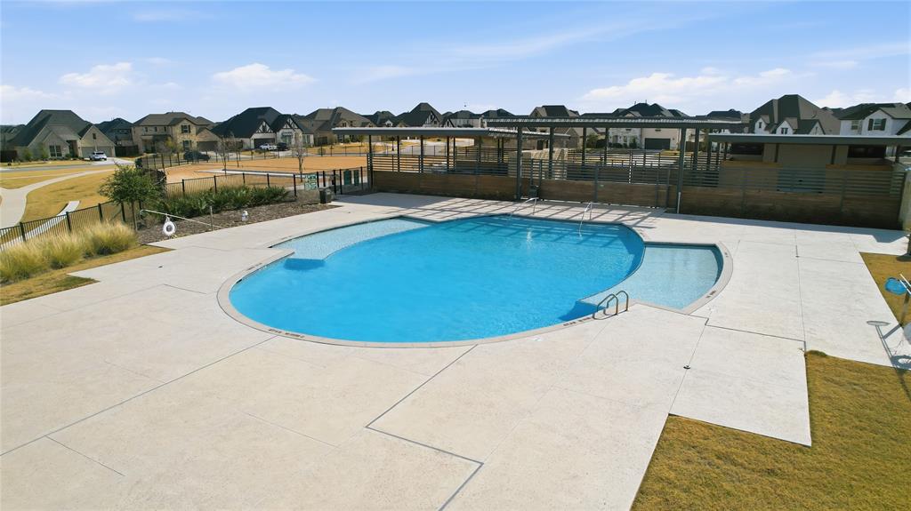 2188 Cloverfern Way Haslet, TX 76052 - Photo 28 of 30 a view of a lake with a houses in the background