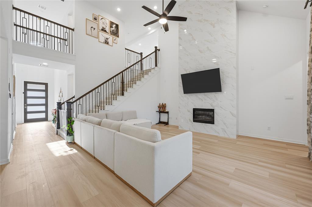 2188 Cloverfern Way Haslet, TX 76052 - Photo 3 of 30 a living room with fireplace furniture and a flat screen tv