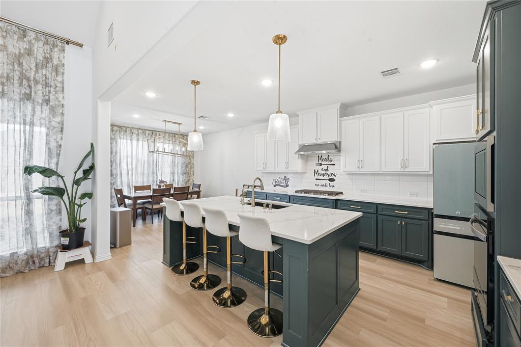 2188 Cloverfern Way Haslet, TX 76052 - Photo 8 of 30 a kitchen with a sink a counter top space appliances and cabinets