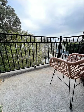 a balcony with a bench in wooden floor