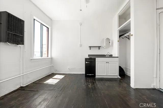 a living room with stainless steel appliances kitchen island granite countertop a stove a sink and a microwave
